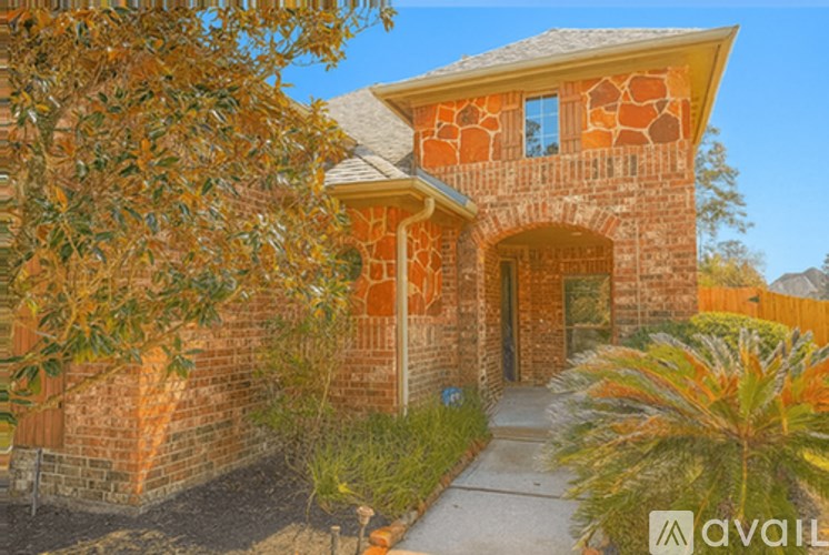 A house with a brick facade and a stone archway entrance.