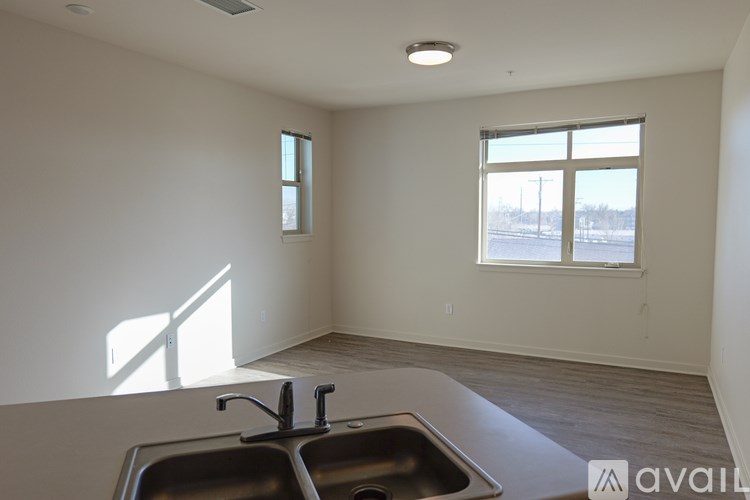 A kitchen with a double sink and a window.