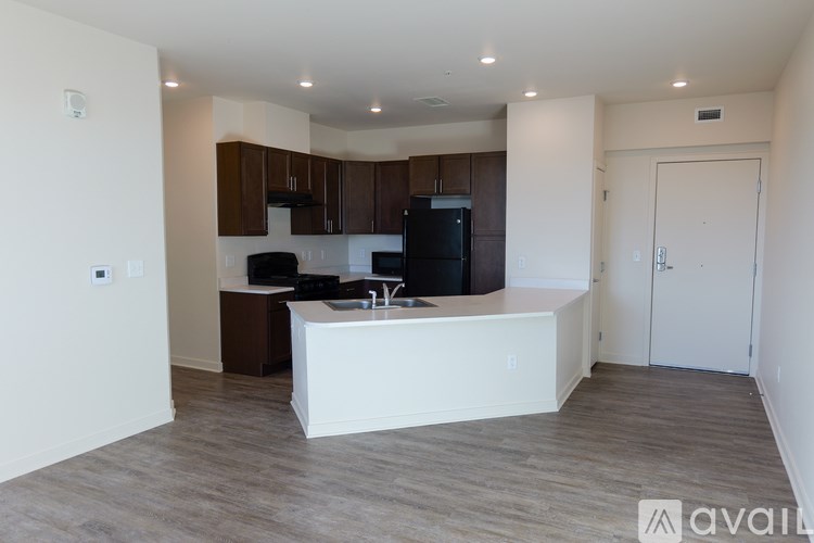 A kitchen with a white island and brown cabinets.