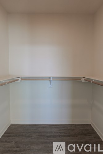 A room with a grey carpet and white walls.