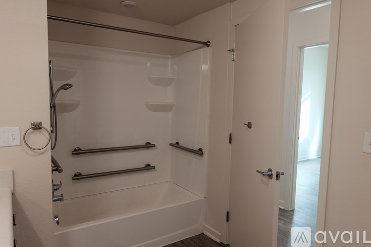 A bathroom with a glass shower stall and a white door.