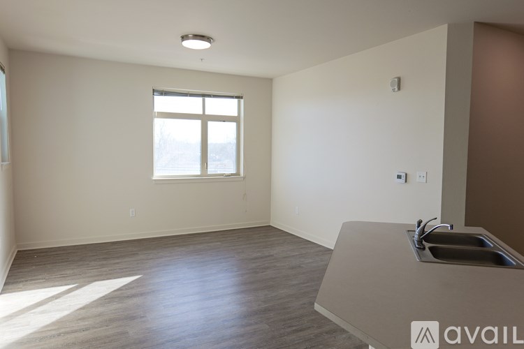A room with a sink and a window.