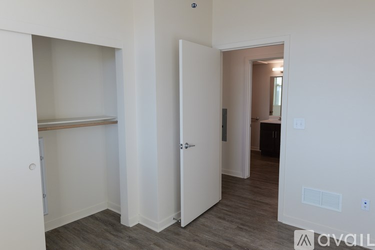 A room with a white door and a shelf.