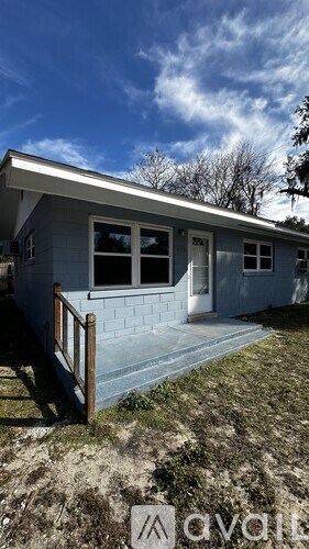 A house with a blue exterior and a white door is for sale.
