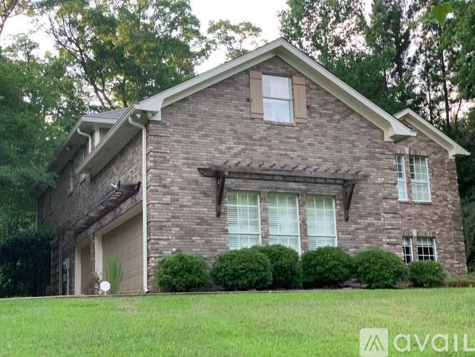 A house with a brick exterior and a pitched roof.