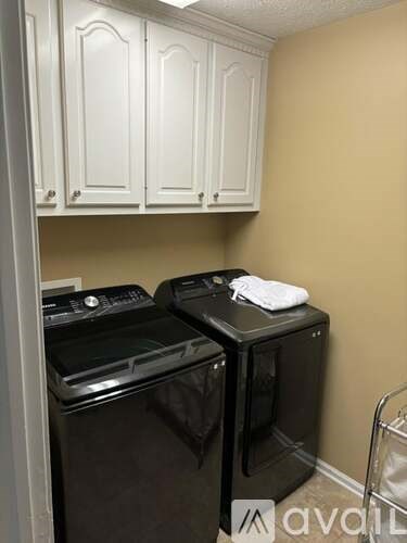 A small laundry room with a washer and dryer.