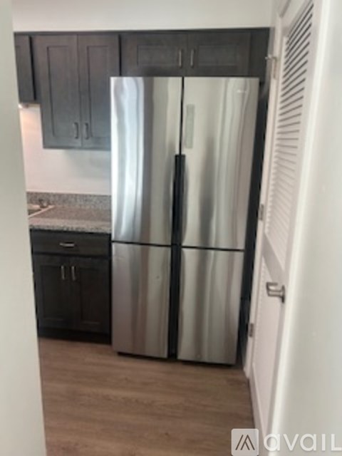 A stainless steel refrigerator in a kitchen.