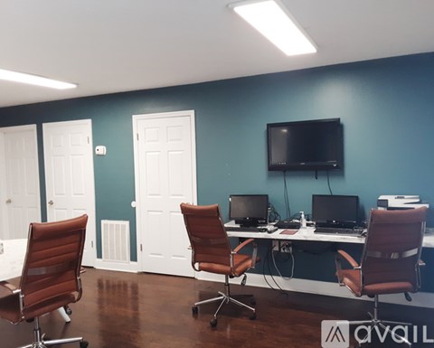 A room with a blue wall and a television mounted on it.