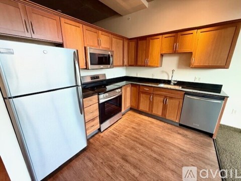 A kitchen with wooden cabinets and a white refrigerator.