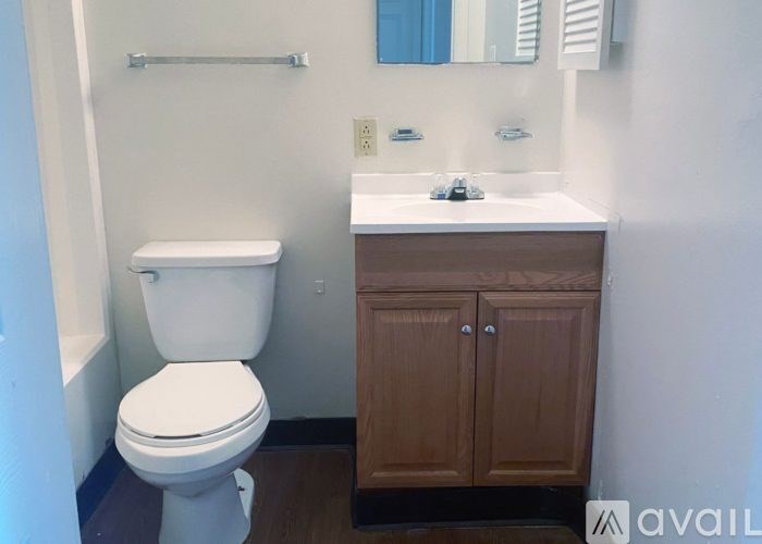 A white toilet sits next to a sink in a bathroom.