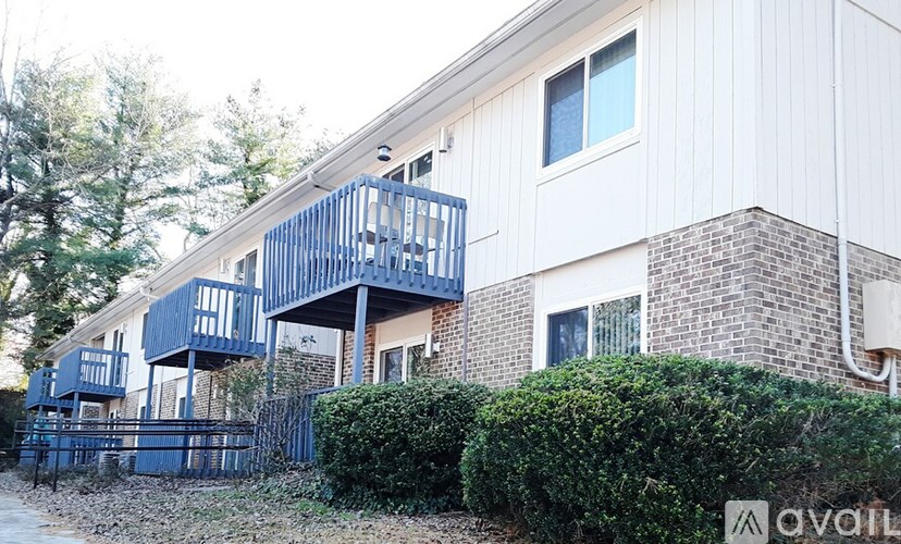 A white house with a blue balcony.