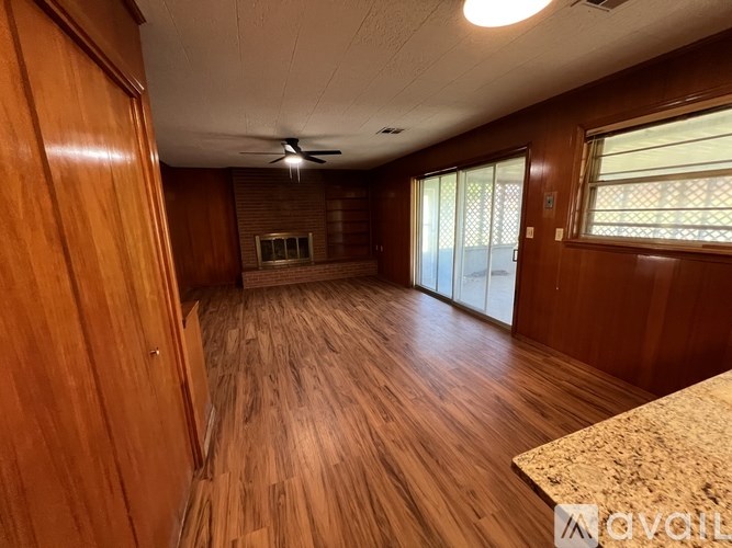 A room with wooden floors and a ceiling fan.