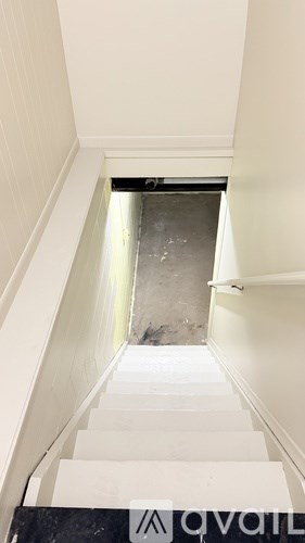 A stairway with a sign that says "available" on the bottom.