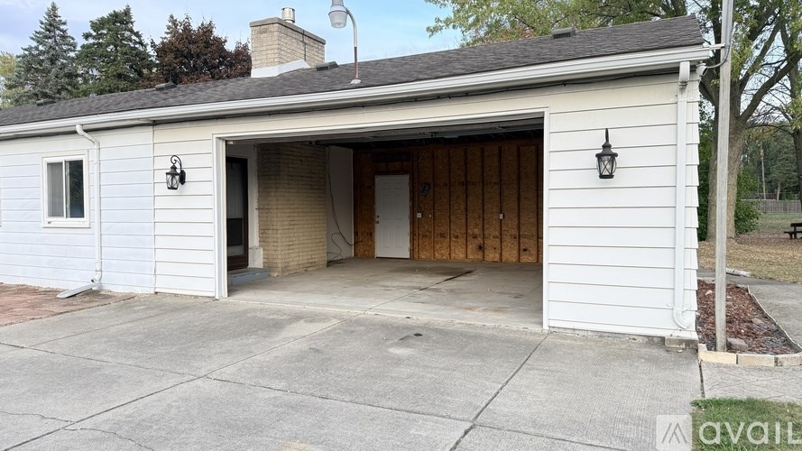 A white garage with a brown door is available for rent.