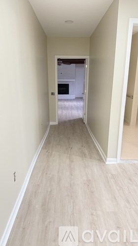 A long hallway with a door at the end.