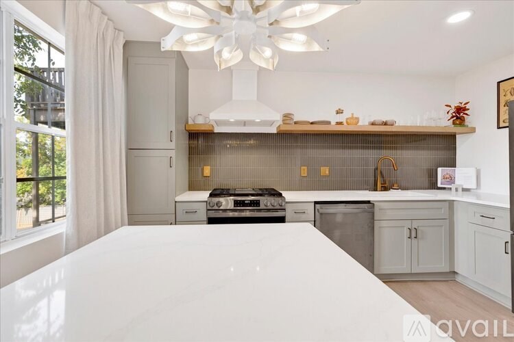 A modern kitchen with a large island in the foreground.