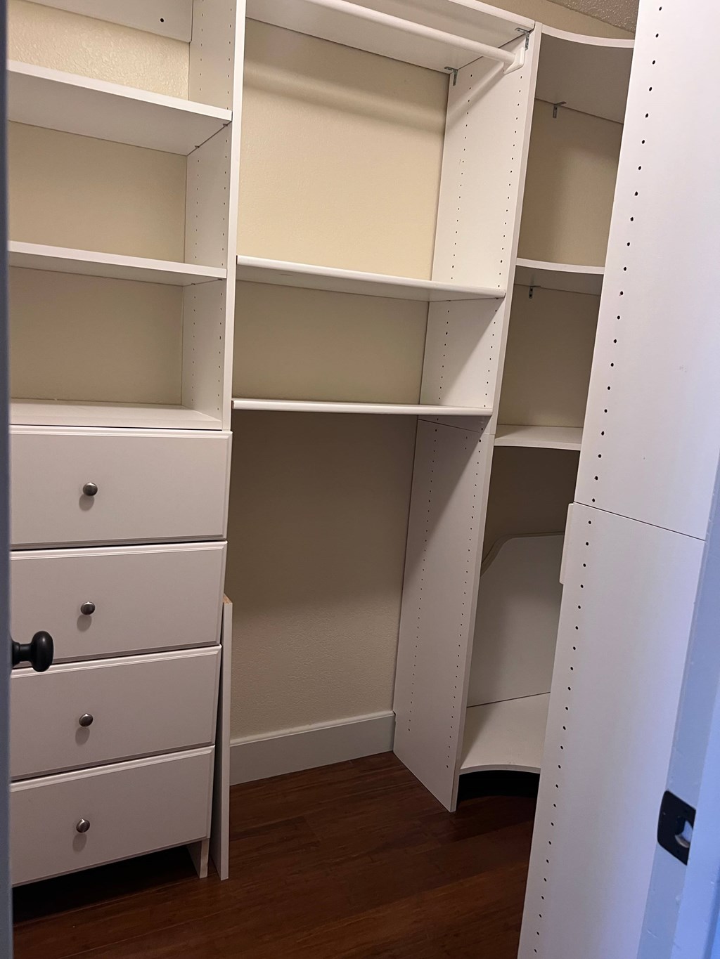 A white closet with shelves and drawers.