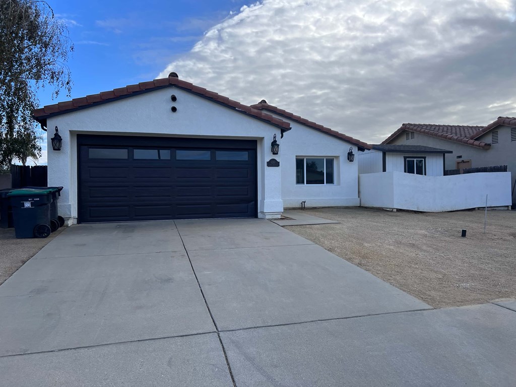 A white house with a black garage door.