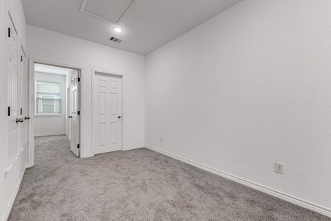 A room with white walls and carpeted floor.