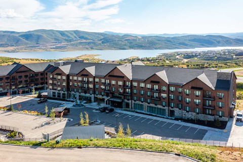A large building with a parking lot in front of it.