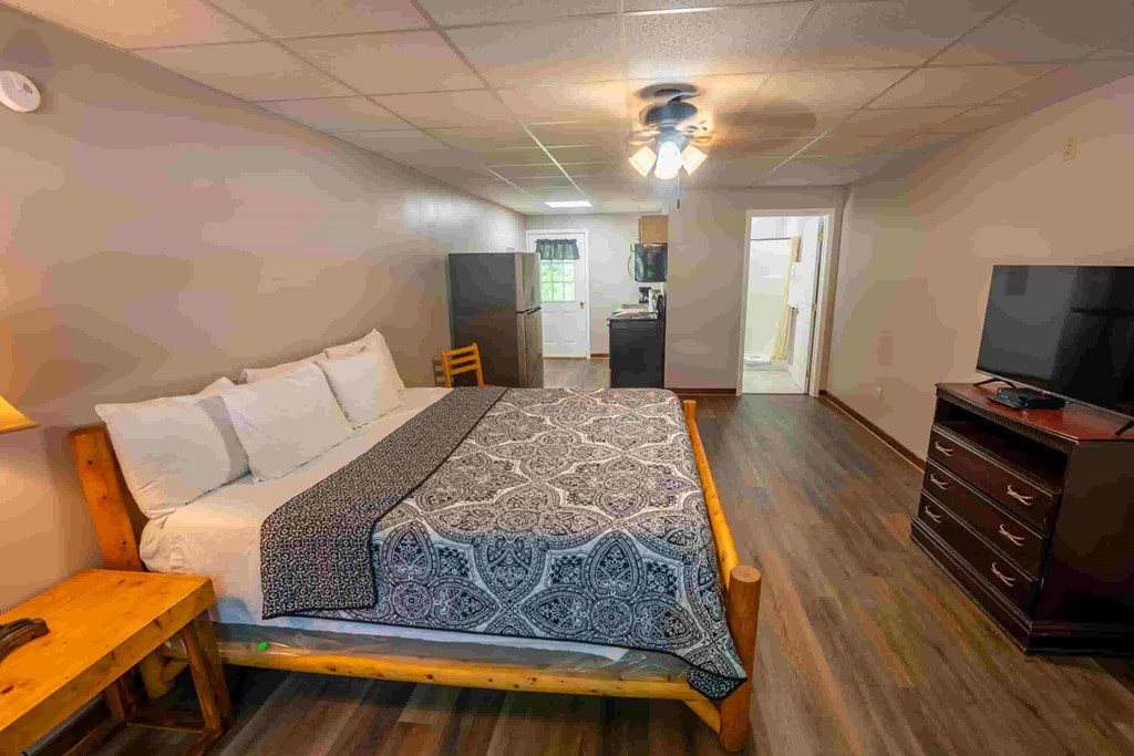 A bedroom with a large bed and a television.