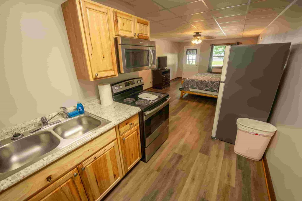 A kitchen with wooden cabinets and a sink.