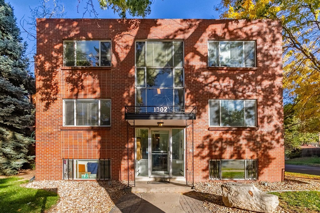 A red brick building with the number 1302 on the front.