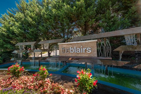 Property entrance sign with waterfall and landscaping at The Blairs Apartments, Silver Spring, 20910