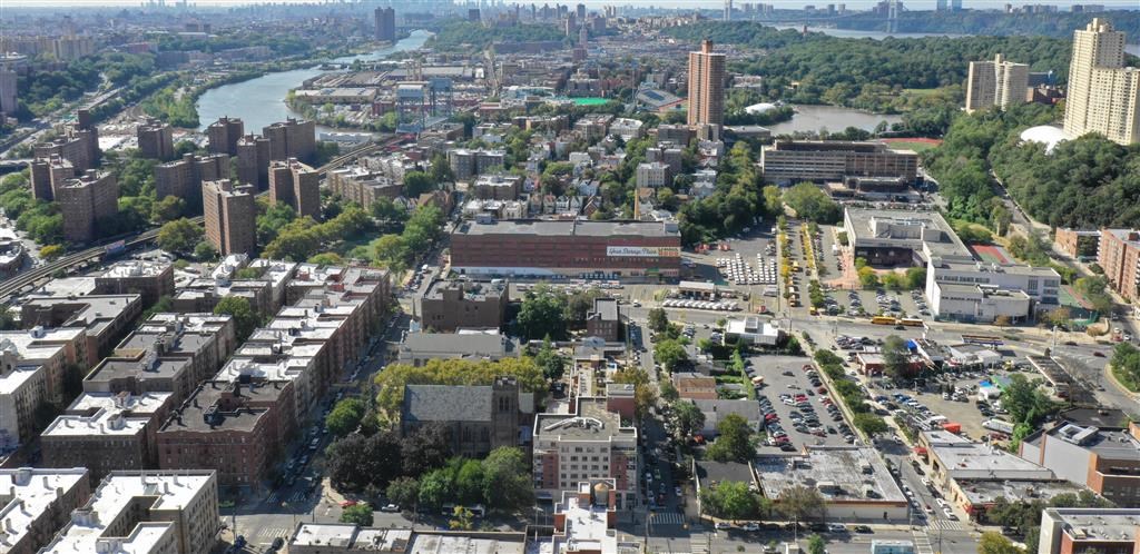 an aerial view of a city with a river and buildings