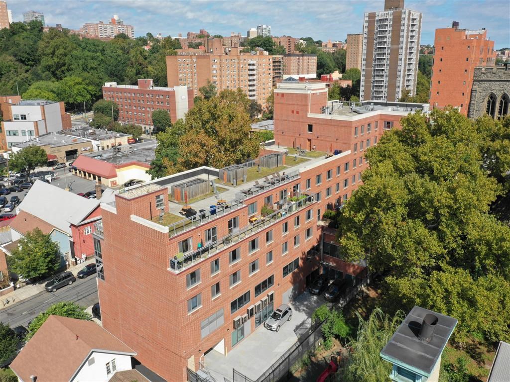 an aerial view of a building with a green roof