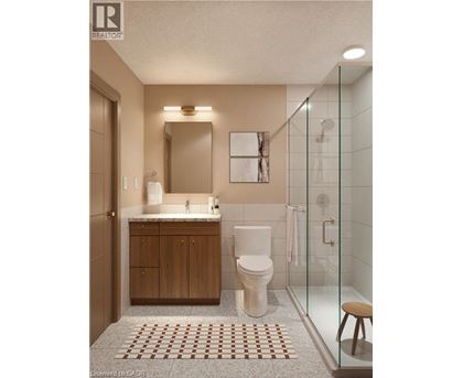 A bathroom with a toilet, sink, and shower.