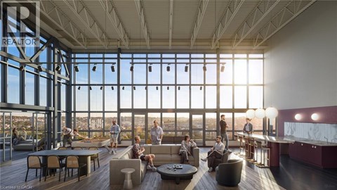 A group of people are gathered in a large room with a view of the city.
