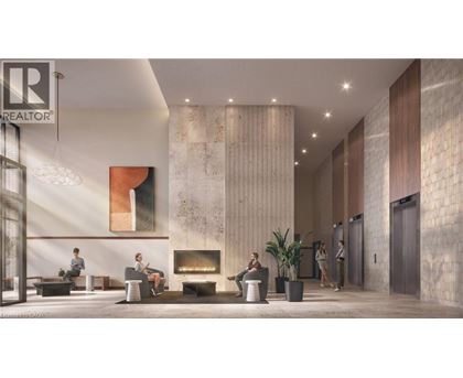 A lobby with a fireplace and people sitting.