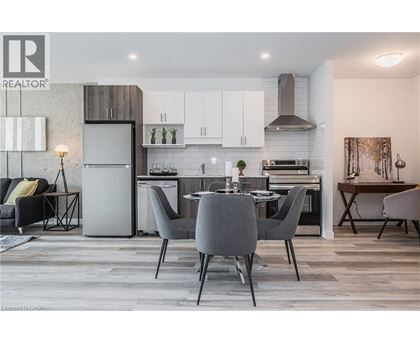 A modern kitchen with a dining table set for four.