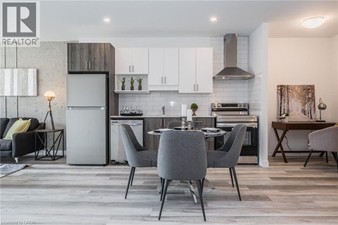 A modern kitchen with a dining table set for four.