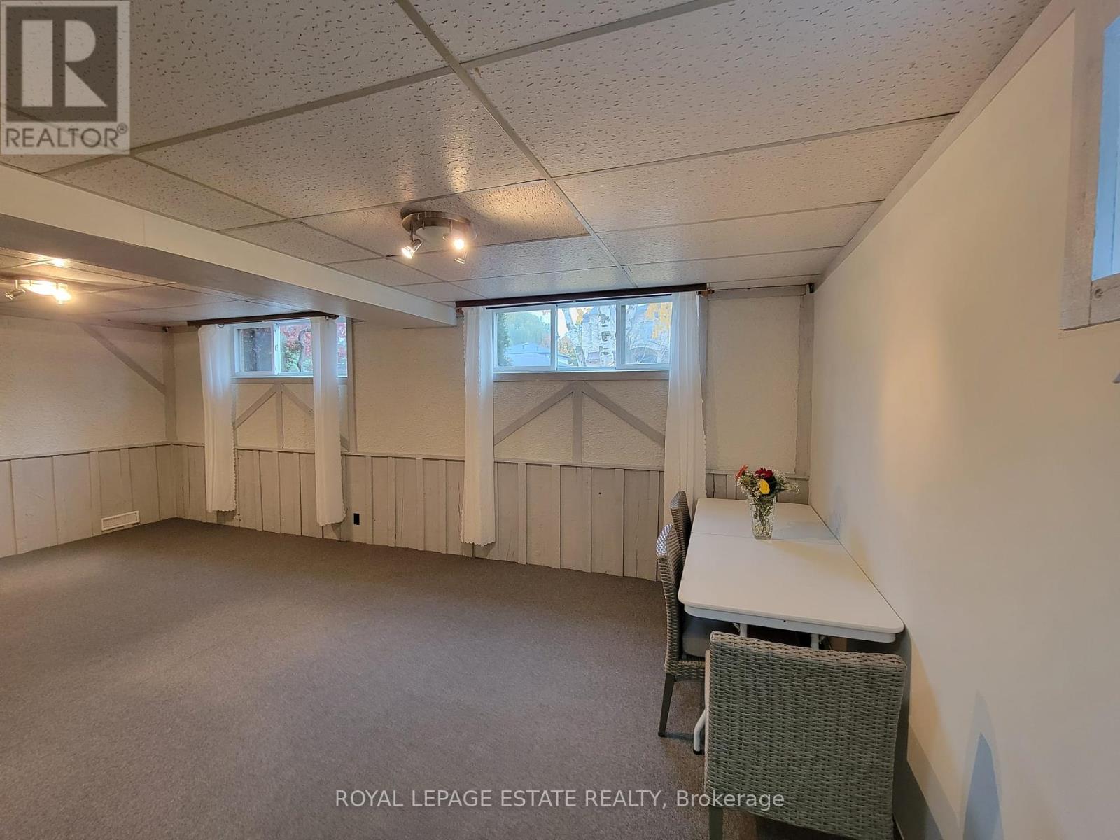 A spacious room with a table and chairs is available for rent.