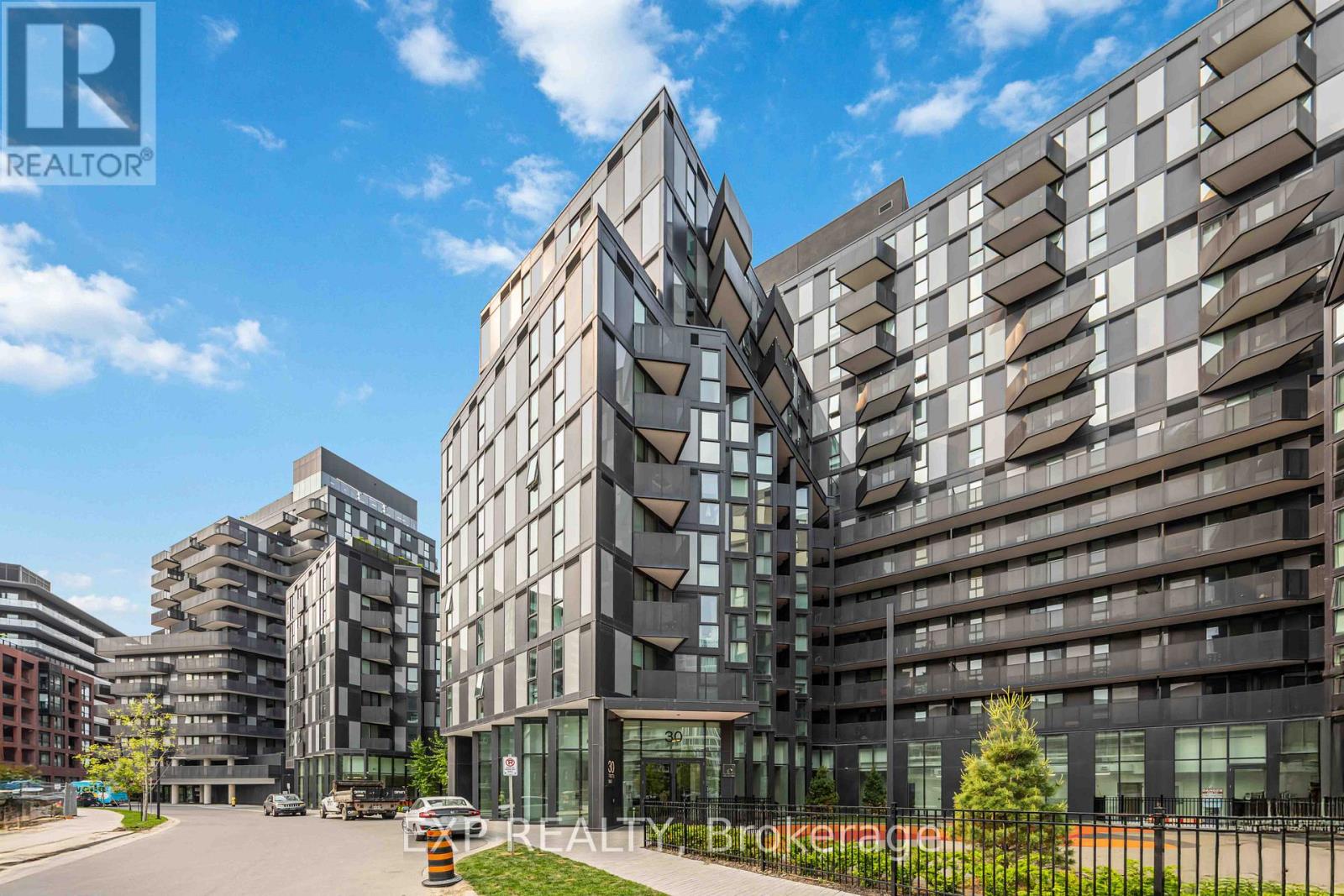 A modern building with a glass facade is the main focus of the image.