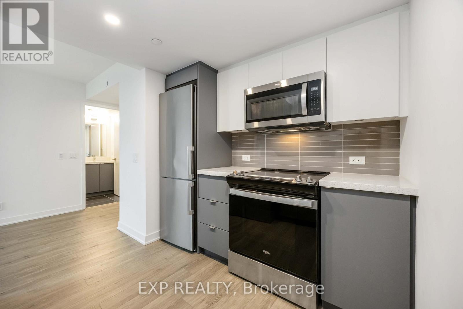 A kitchen with a stove top oven and a microwave above it.
