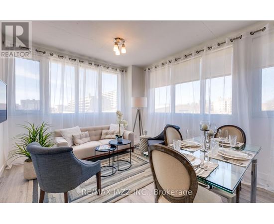 A dining room with a glass table and chairs.