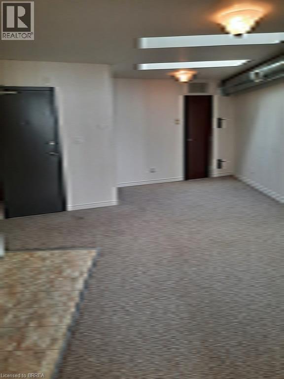 A room with a rug on the floor and a door on the left side.