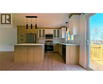 A modern kitchen with wooden cabinets and a large island.