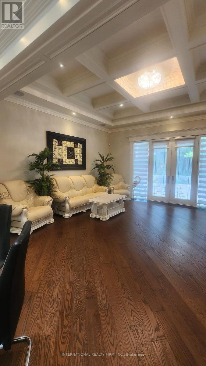 A living room with a white sofa and a wooden floor.
