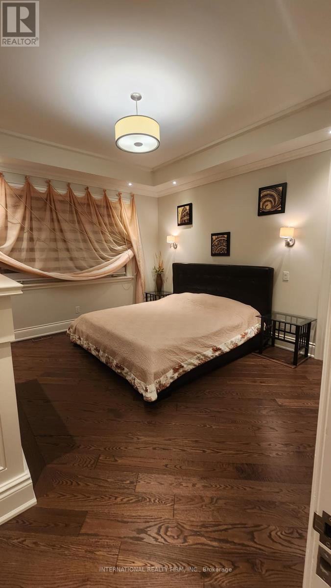 A bedroom with a bed, a canopy, and pictures on the wall.