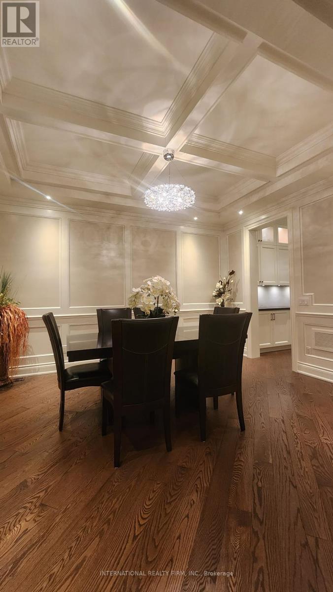 A dining room with a wooden table and chairs.