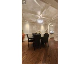 A dining room with a wooden table and chairs.