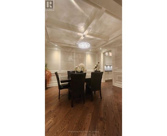 A dining room with a wooden table and chairs.