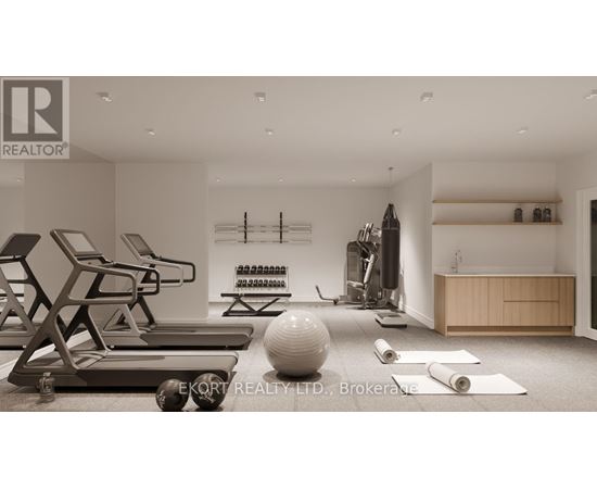 A gym with a variety of equipment including a treadmill, weights, and a yoga mat.