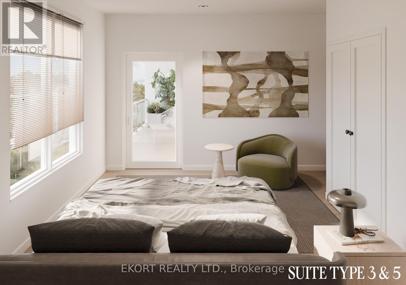 A bedroom with a bed, a green chair, and a painting on the wall.
