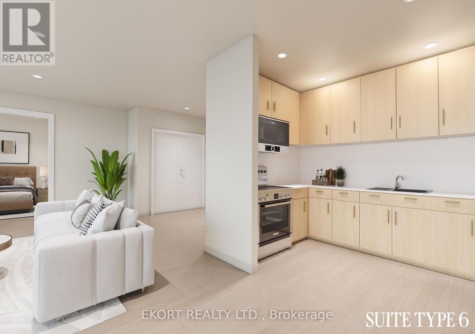 A modern kitchen with wooden cabinets and a white sofa.