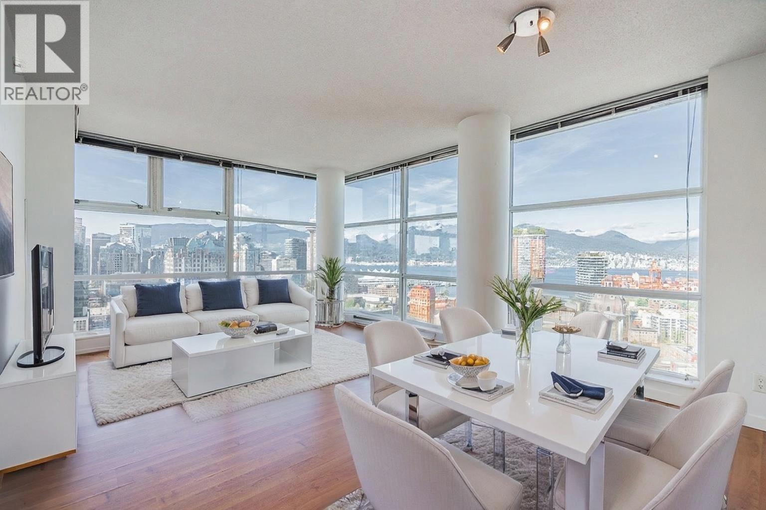 A well-lit, modern living room with a view of the cityscape.